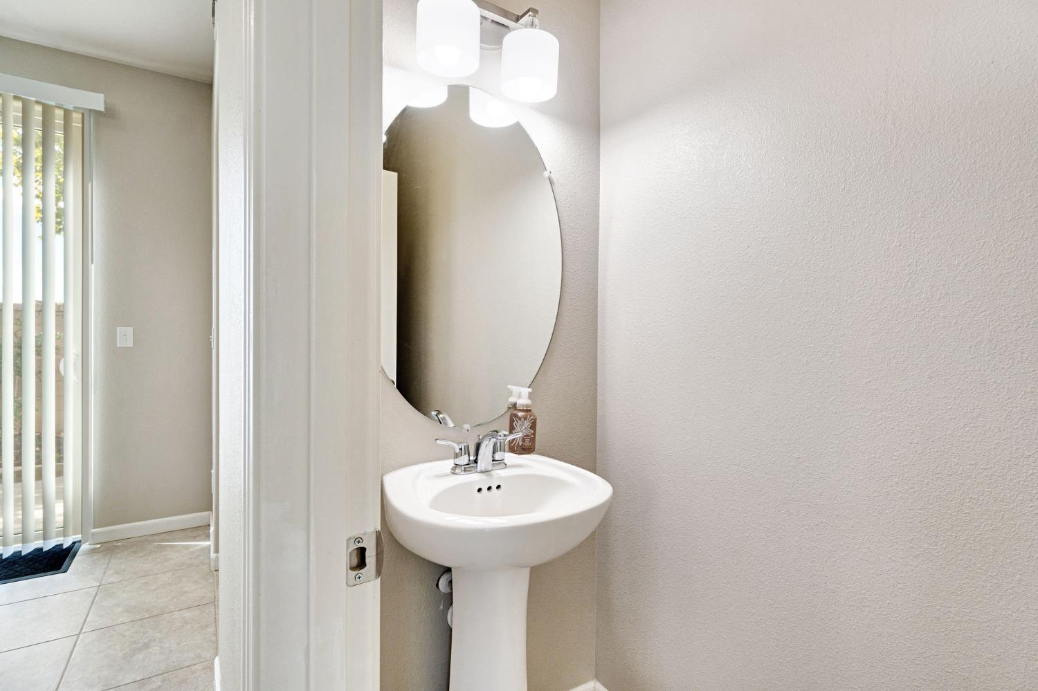 1500 North Encoure Way Clovis, CA 93619 - Photo 13 of 37 a bathroom with a sink and a mirror