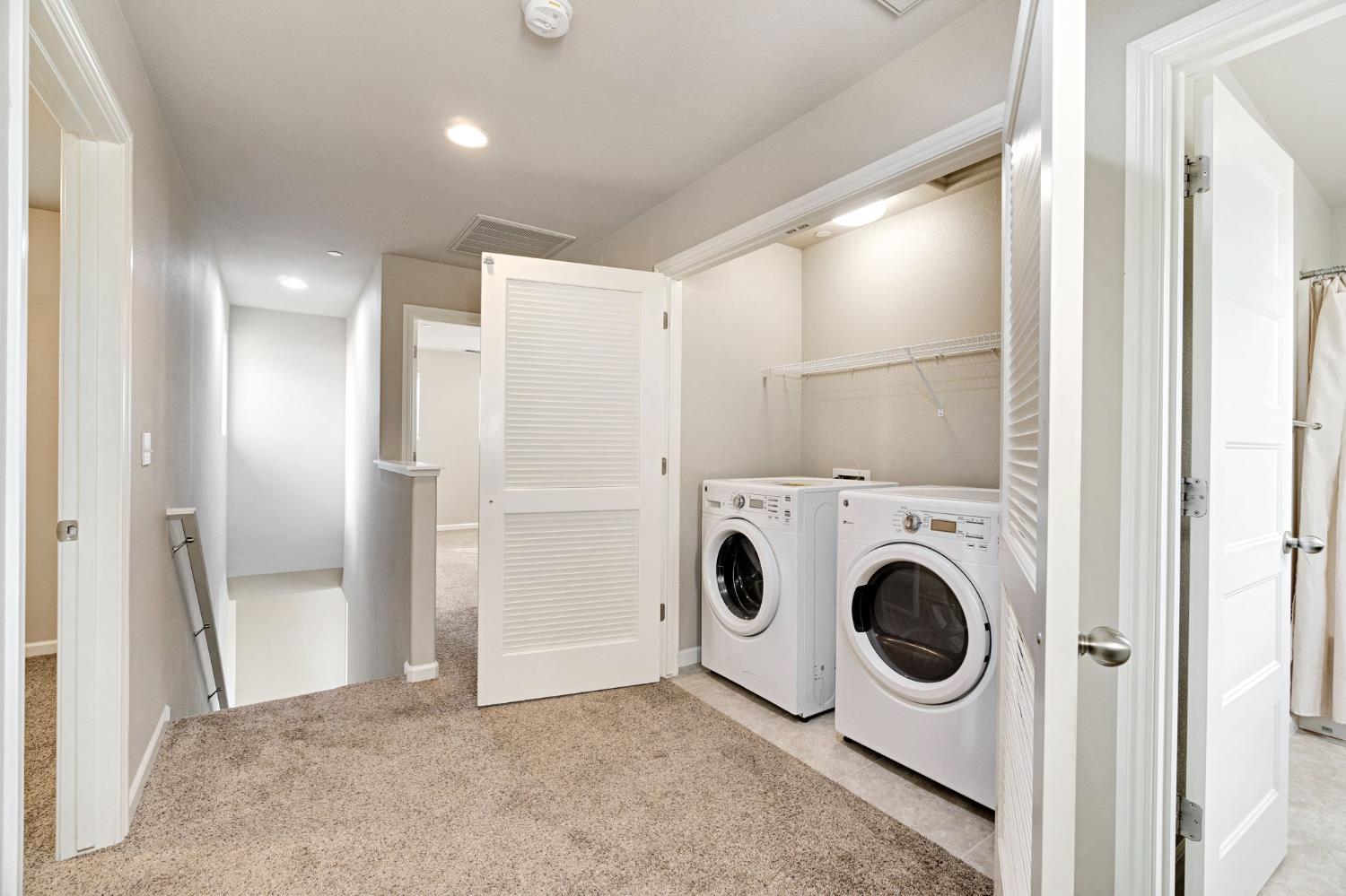 1500 North Encoure Way Clovis, CA 93619 - Photo 16 of 37 a view of a storage & utility room with dryer and washer