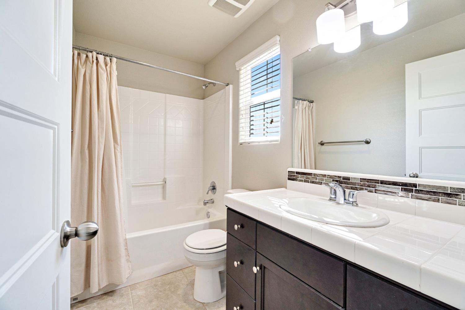 1500 North Encoure Way Clovis, CA 93619 - Photo 25 of 37 a bathroom with a granite countertop sink toilet and shower