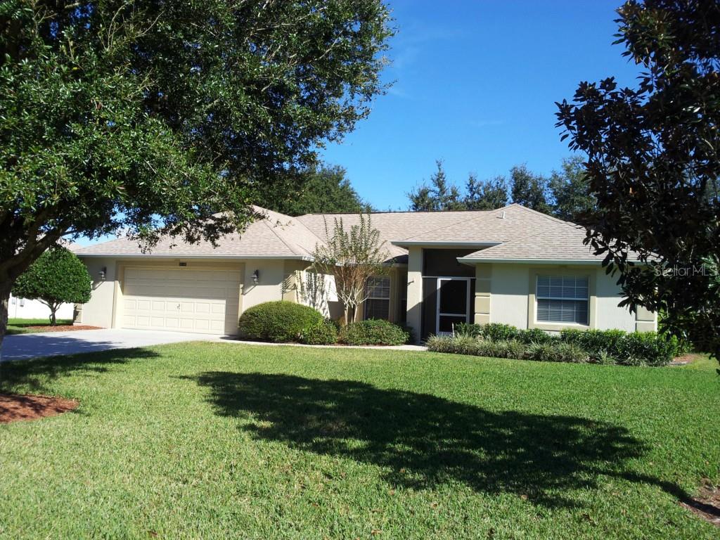 Beautiful one story home with oversized garage and mature trees.