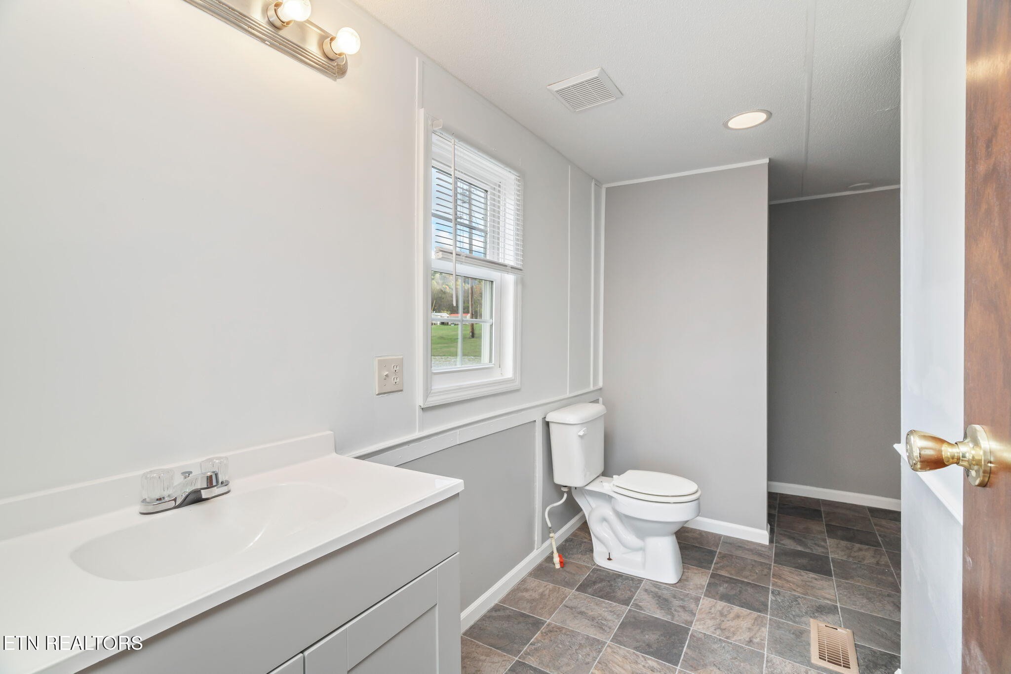 361 Doane Road New Market, TN 37820 - Photo 20 of 39 a bathroom with a sink toilet and a mirror