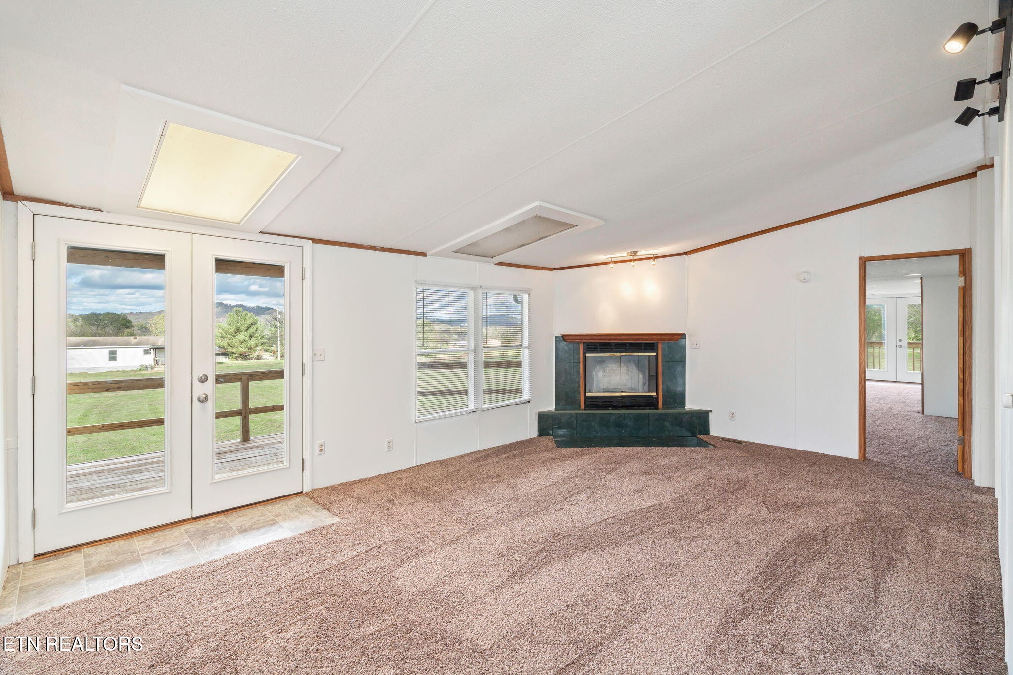 361 Doane Road New Market, TN 37820 - Photo 7 of 39 a view of an empty room with a window and fire place