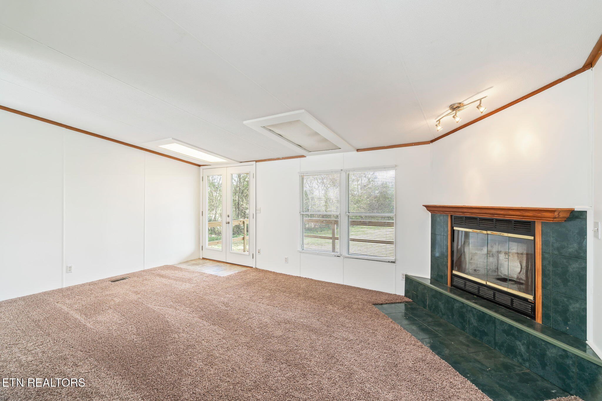 361 Doane Road New Market, TN 37820 - Photo 8 of 39 a view of empty room with fireplace and large window