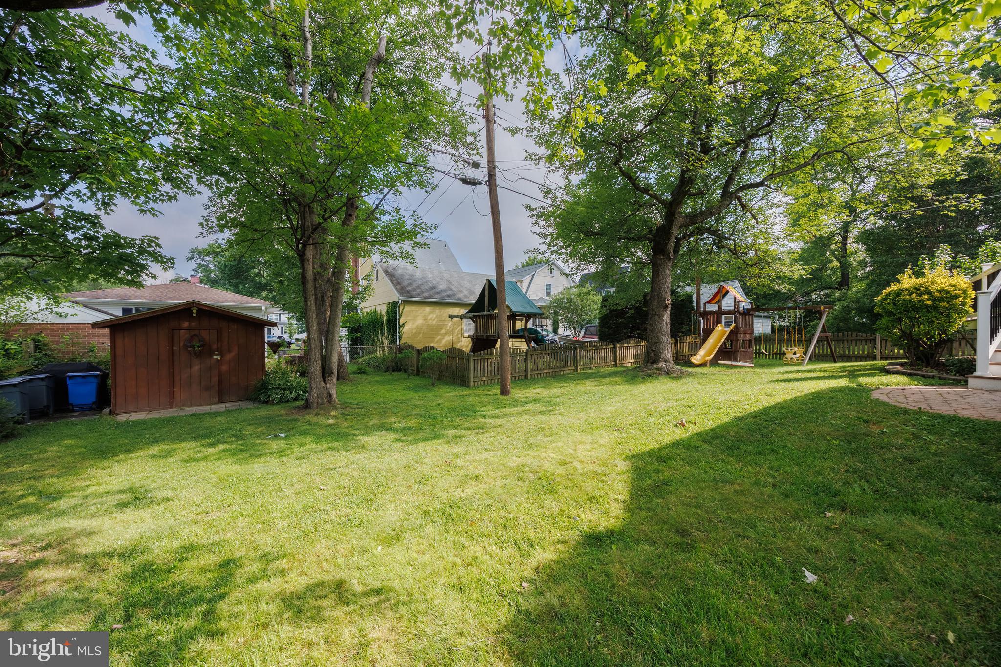 1310 Brook Road Baltimore, MD 21228 - Photo 50 of 67 grassy yard w/ trees, a shed, and a small playset