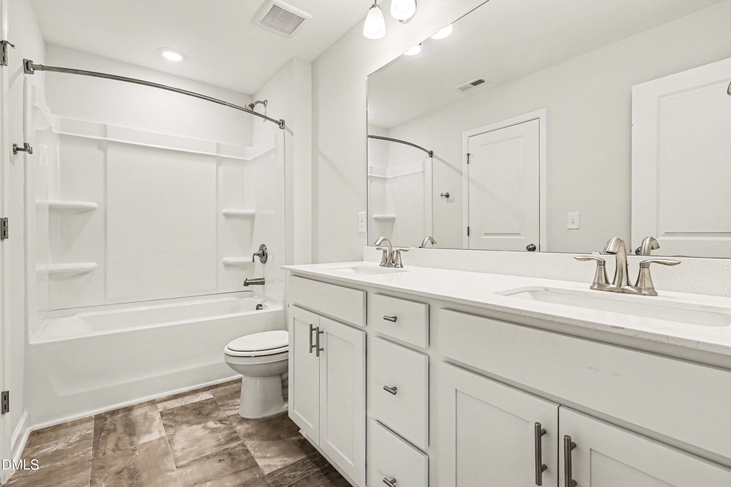 90 Rigsby Avenue Four Oaks, NC 27524 - Photo 31 of 43 a bathroom with a double vanity sink toilet mirror and bathtub