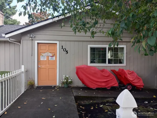 a view of a house with a sink and wooden fence