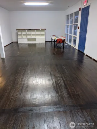 a view of water heater room with wooden floor