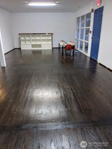 a view of water heater room with wooden floor