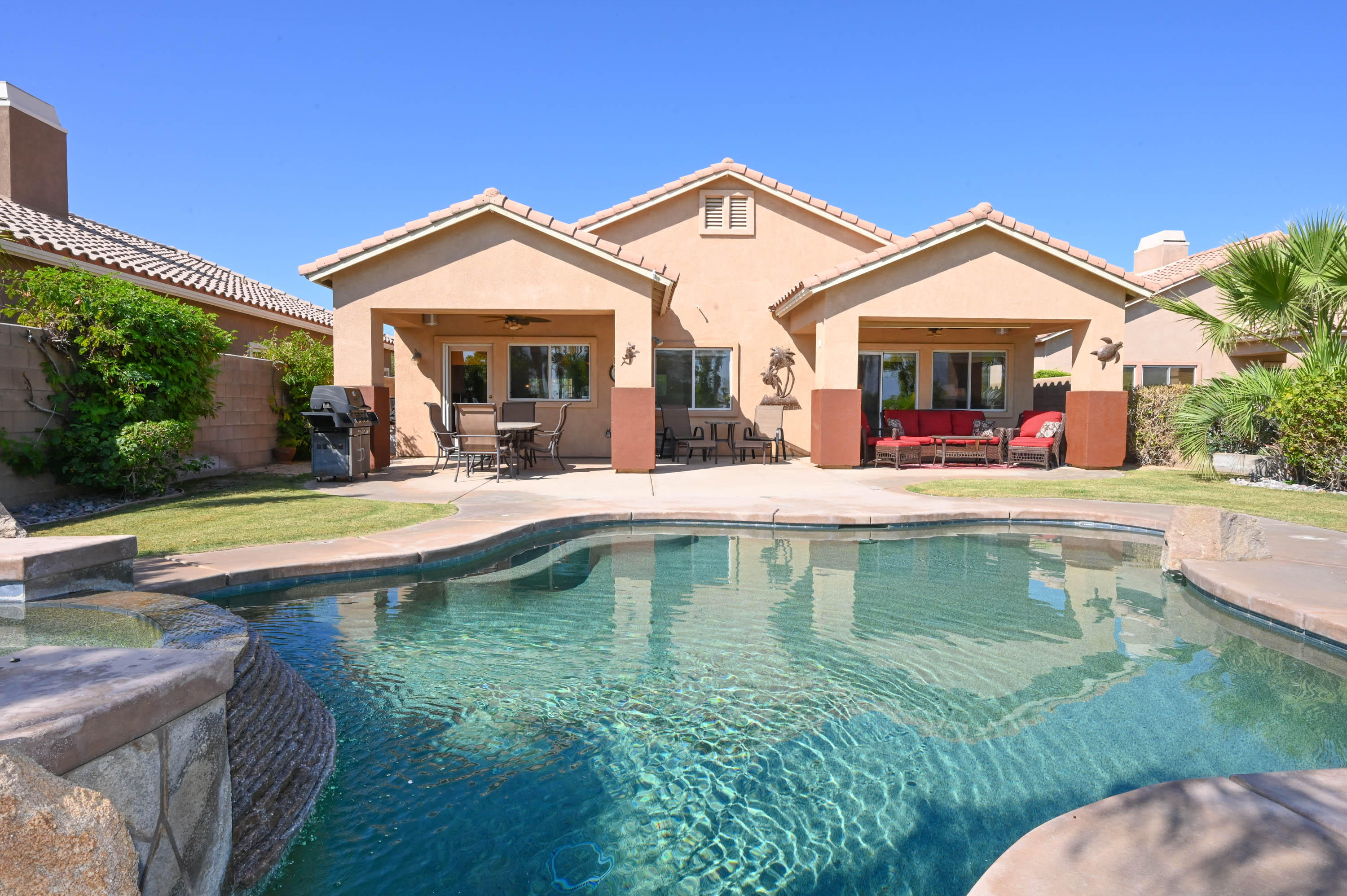 a view of a house with swimming pool and a yard