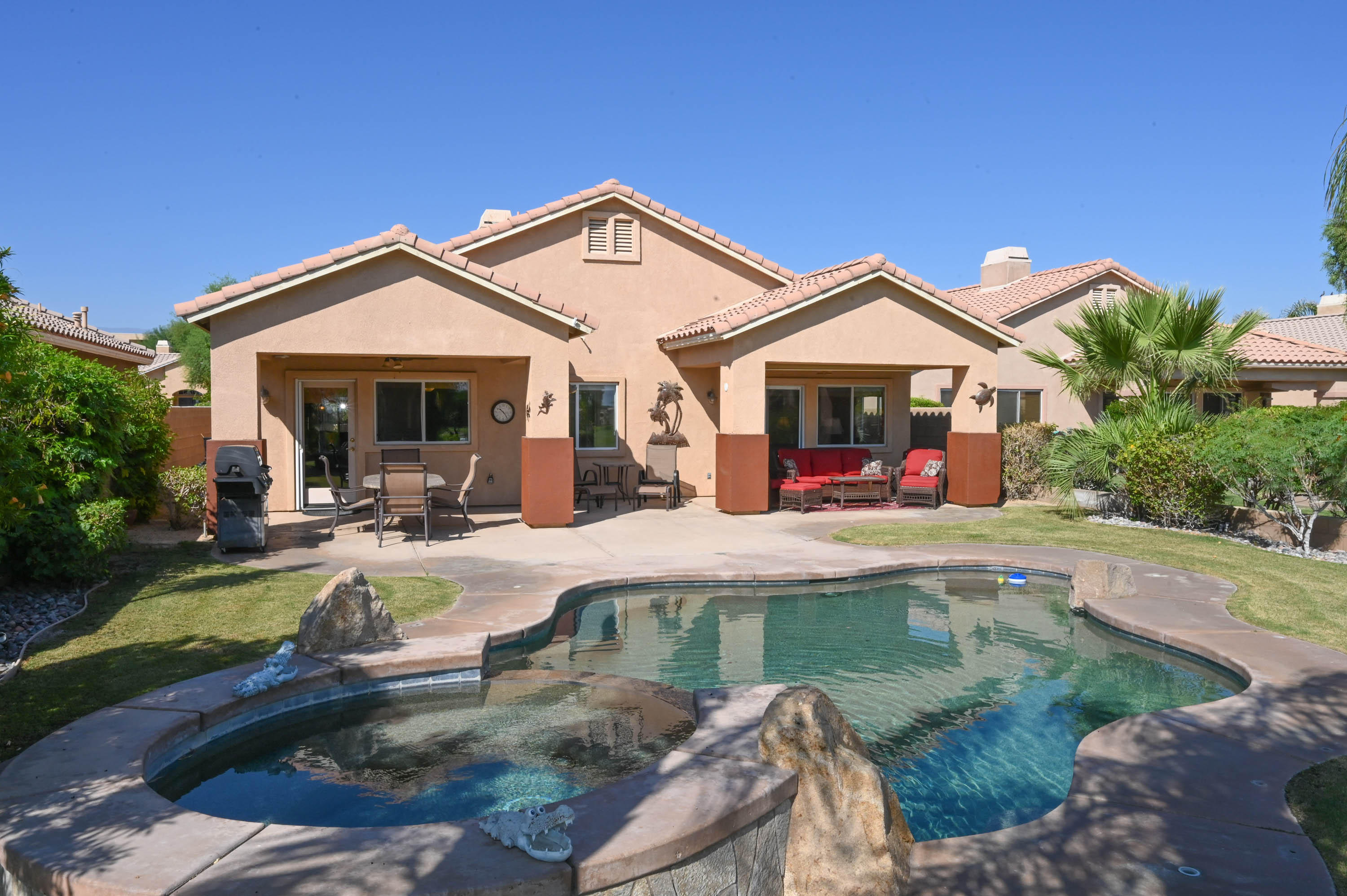 45204 Banff Springs Street Indio, CA 92201 - Photo 2 of 36 a view of a house with swimming pool and sitting area