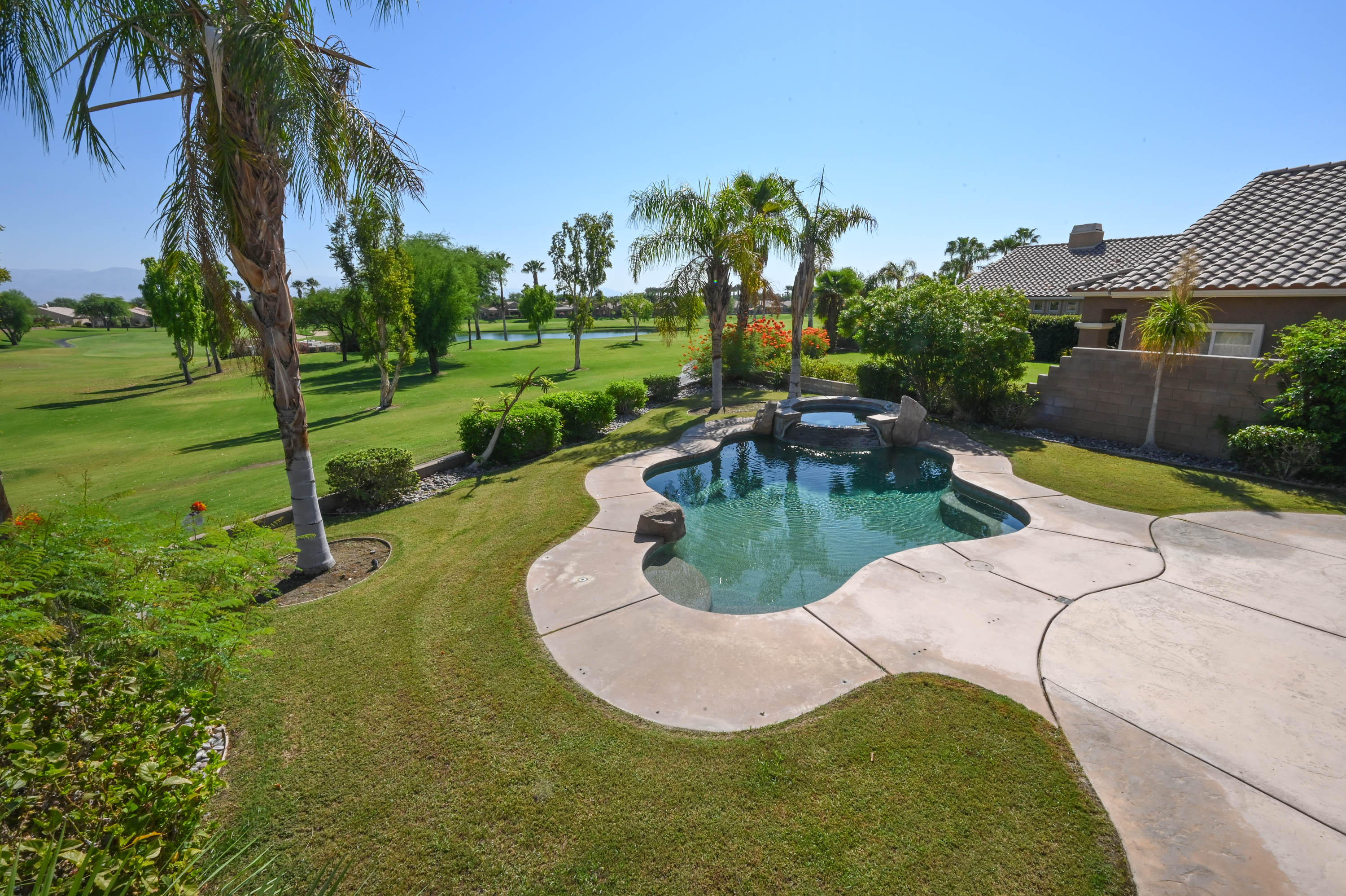 45204 Banff Springs Street Indio, CA 92201 - Photo 12 of 36 a view of a swimming pool with a patio