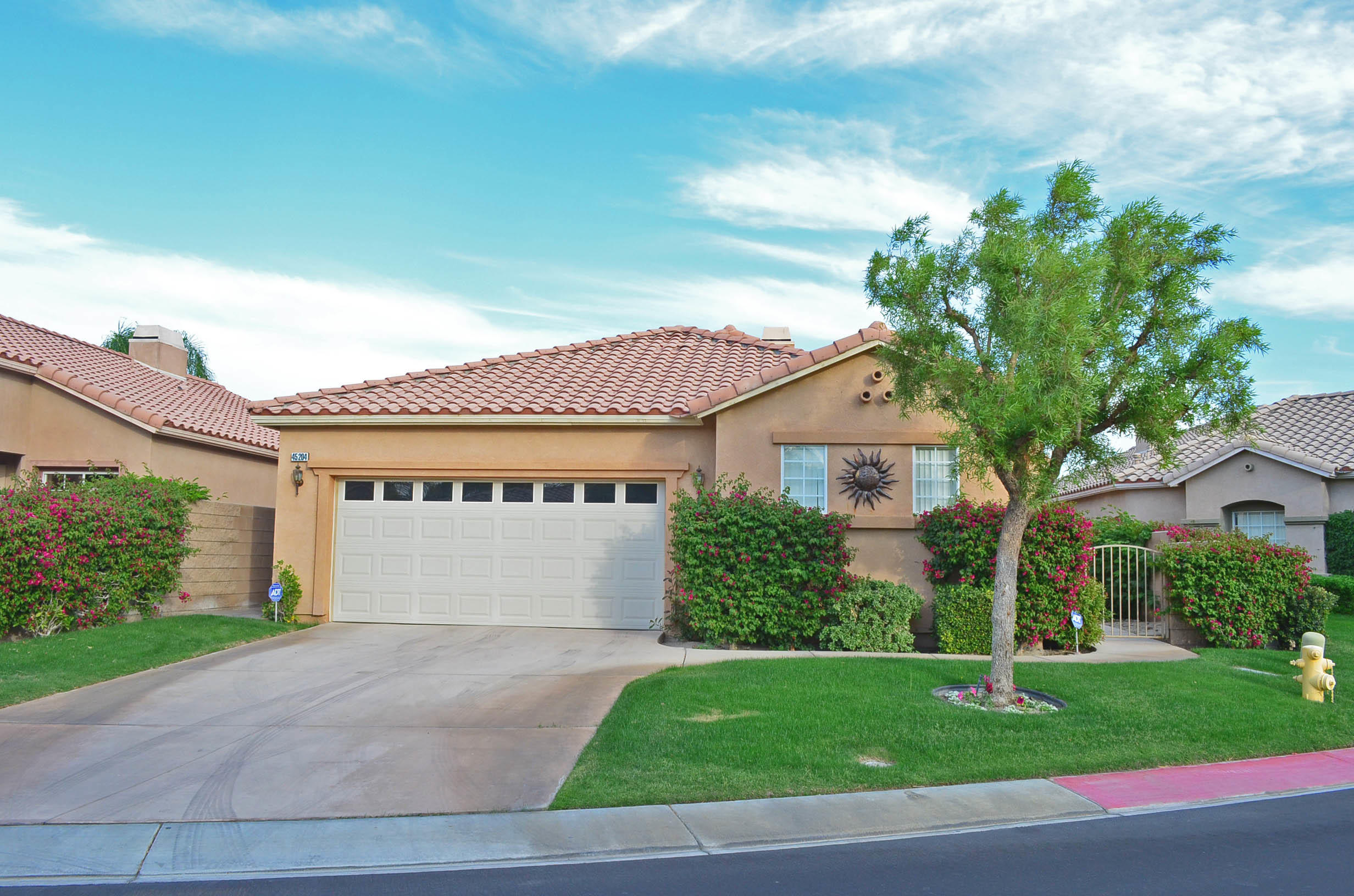 45204 Banff Springs Street Indio, CA 92201 - Photo 15 of 36 a front view of a house with a garden