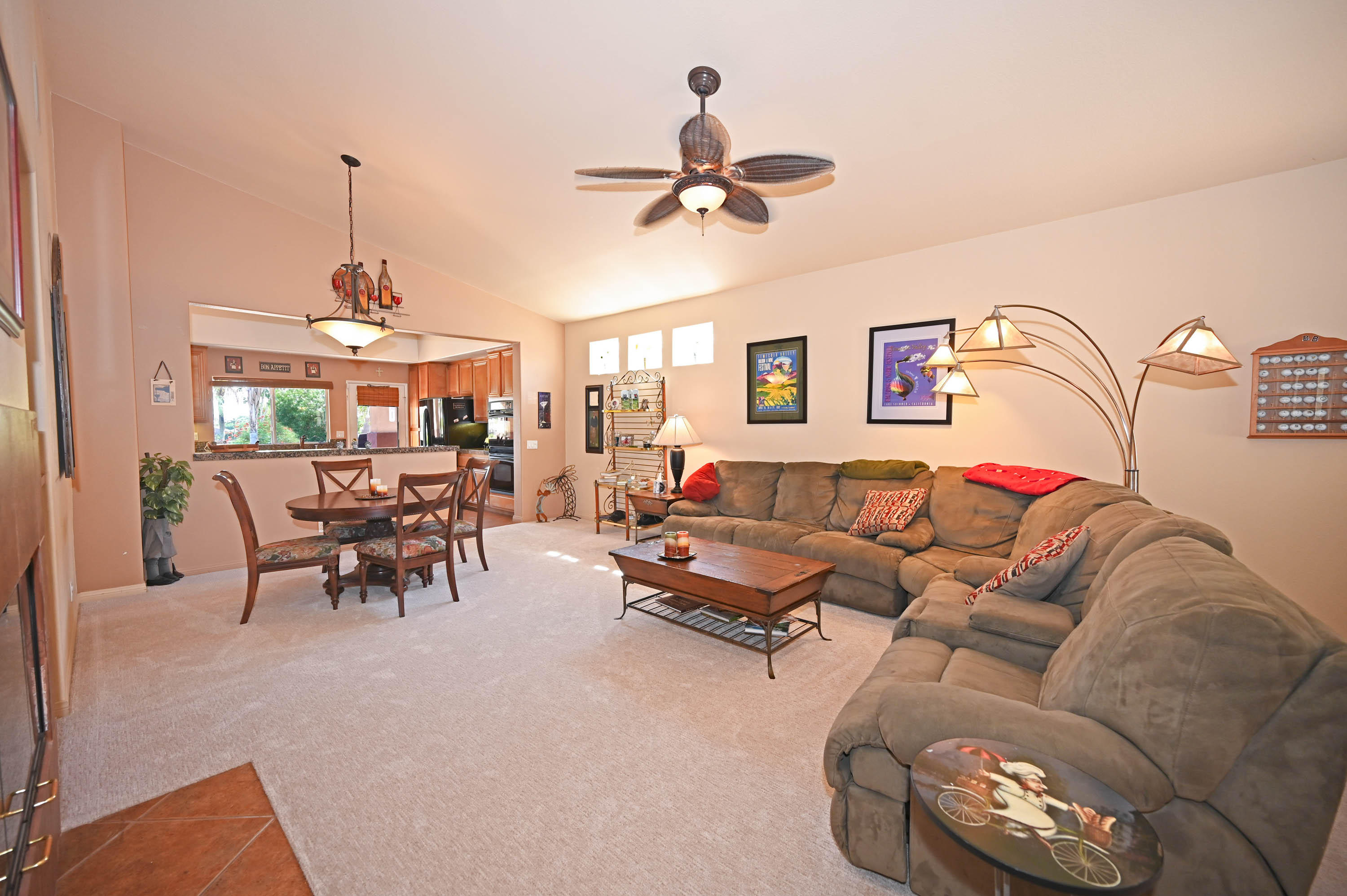 45204 Banff Springs Street Indio, CA 92201 - Photo 16 of 36 a living room with furniture and a chandelier