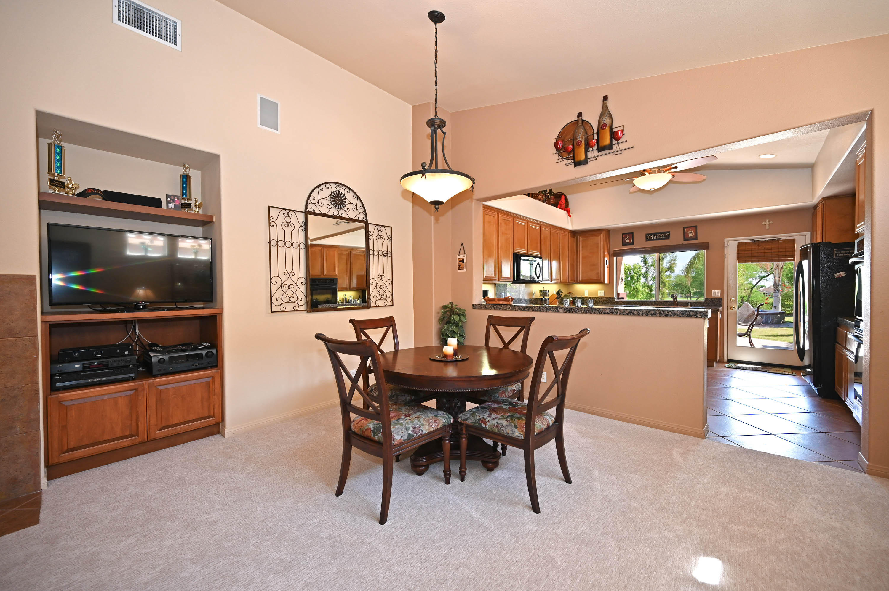 45204 Banff Springs Street Indio, CA 92201 - Photo 18 of 36 a view of a dining room with furniture and chandelier