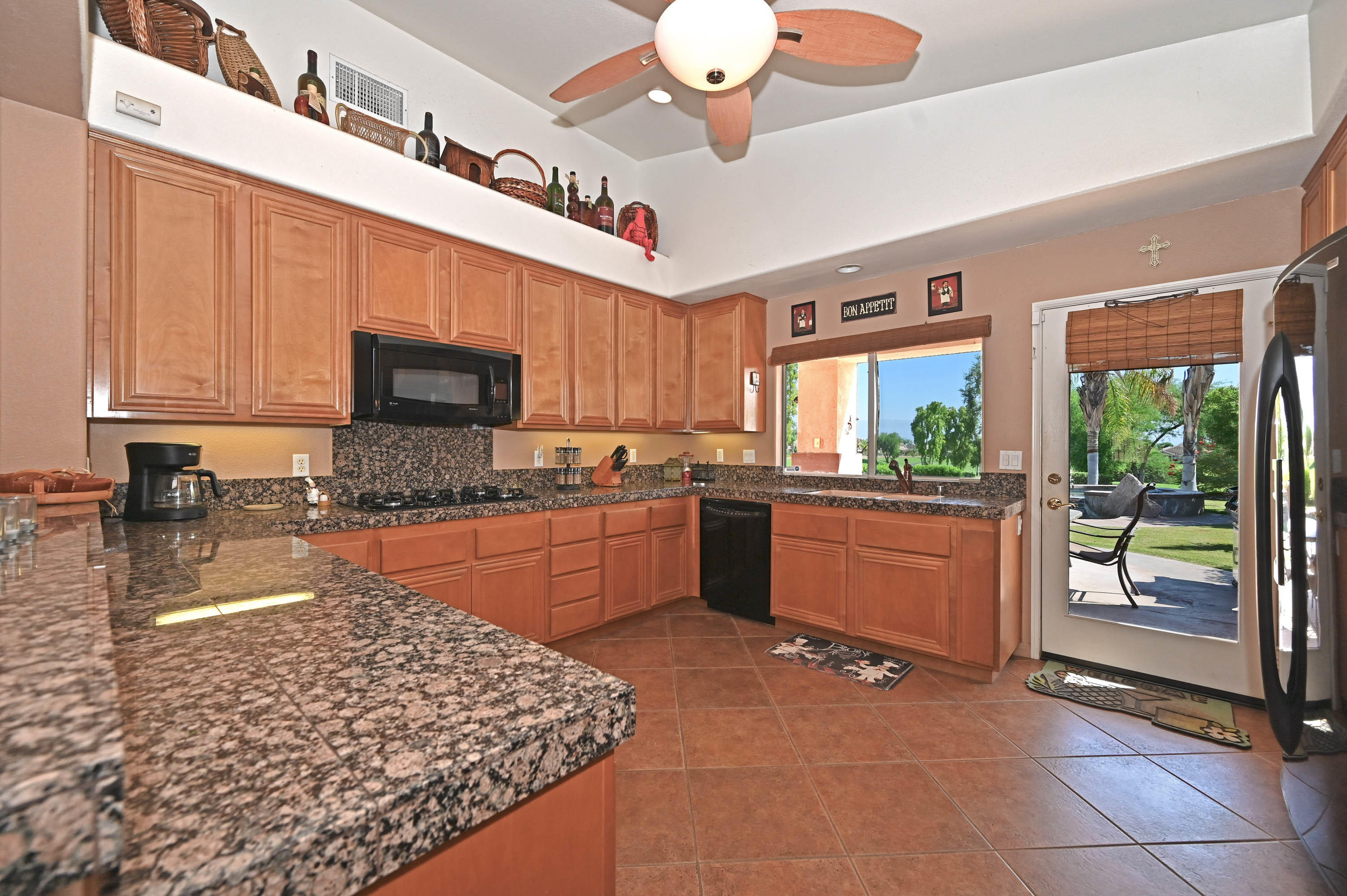 45204 Banff Springs Street Indio, CA 92201 - Photo 19 of 36 a kitchen with stainless steel appliances granite countertop a stove sink and cabinets