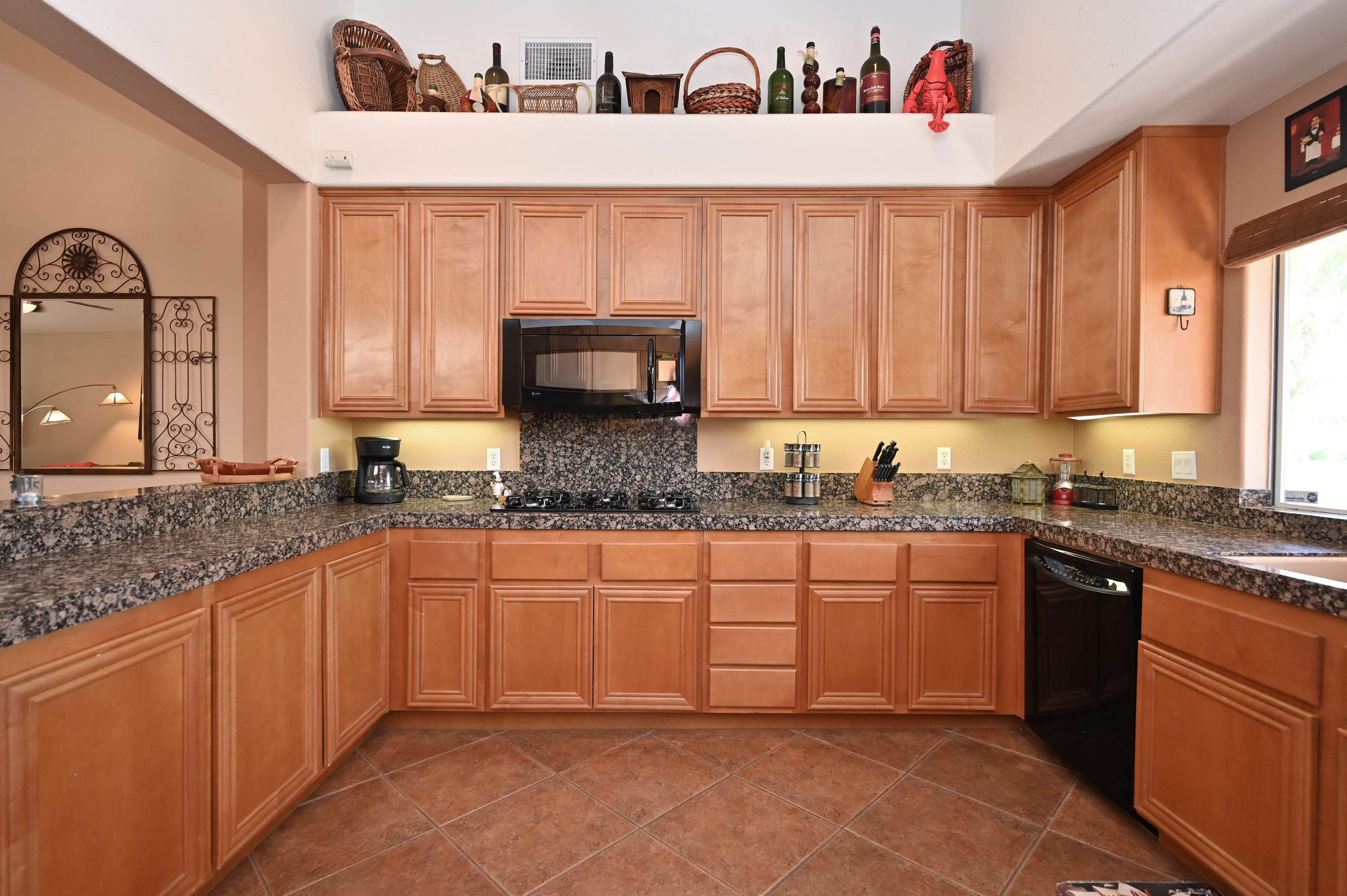 45204 Banff Springs Street Indio, CA 92201 - Photo 20 of 36 a kitchen with stainless steel appliances granite countertop a sink stove and cabinets