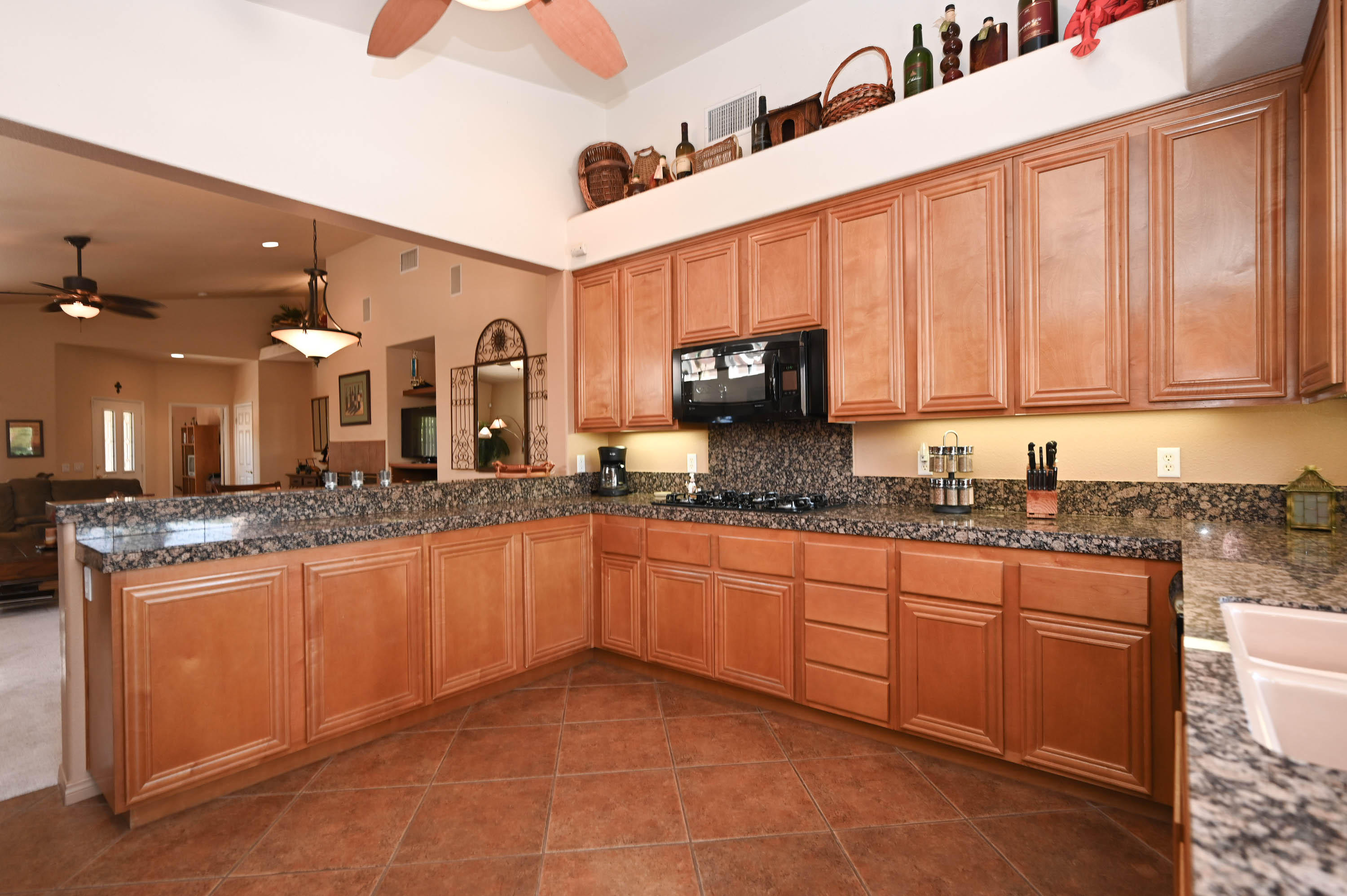 45204 Banff Springs Street Indio, CA 92201 - Photo 21 of 36 a large kitchen with stainless steel appliances granite countertop a sink and cabinets