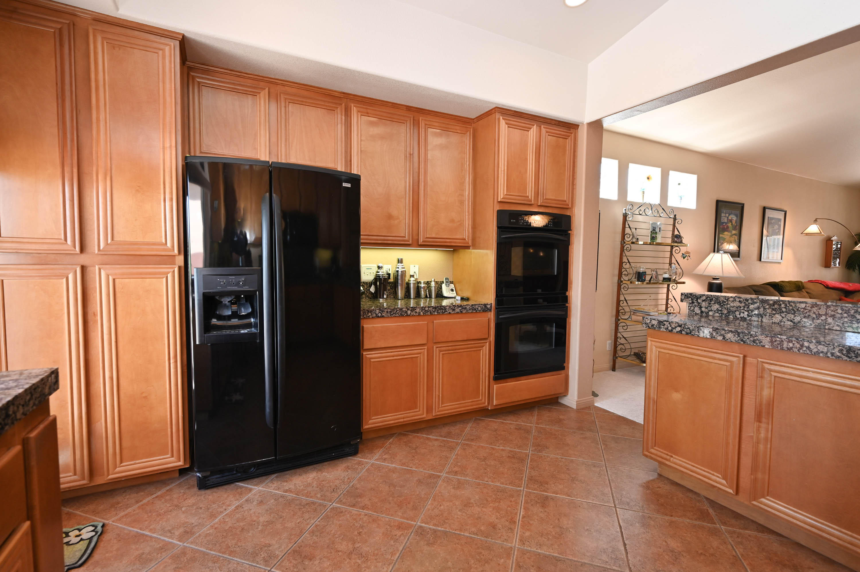 45204 Banff Springs Street Indio, CA 92201 - Photo 22 of 36 a kitchen with stainless steel appliances granite countertop a refrigerator and a stove