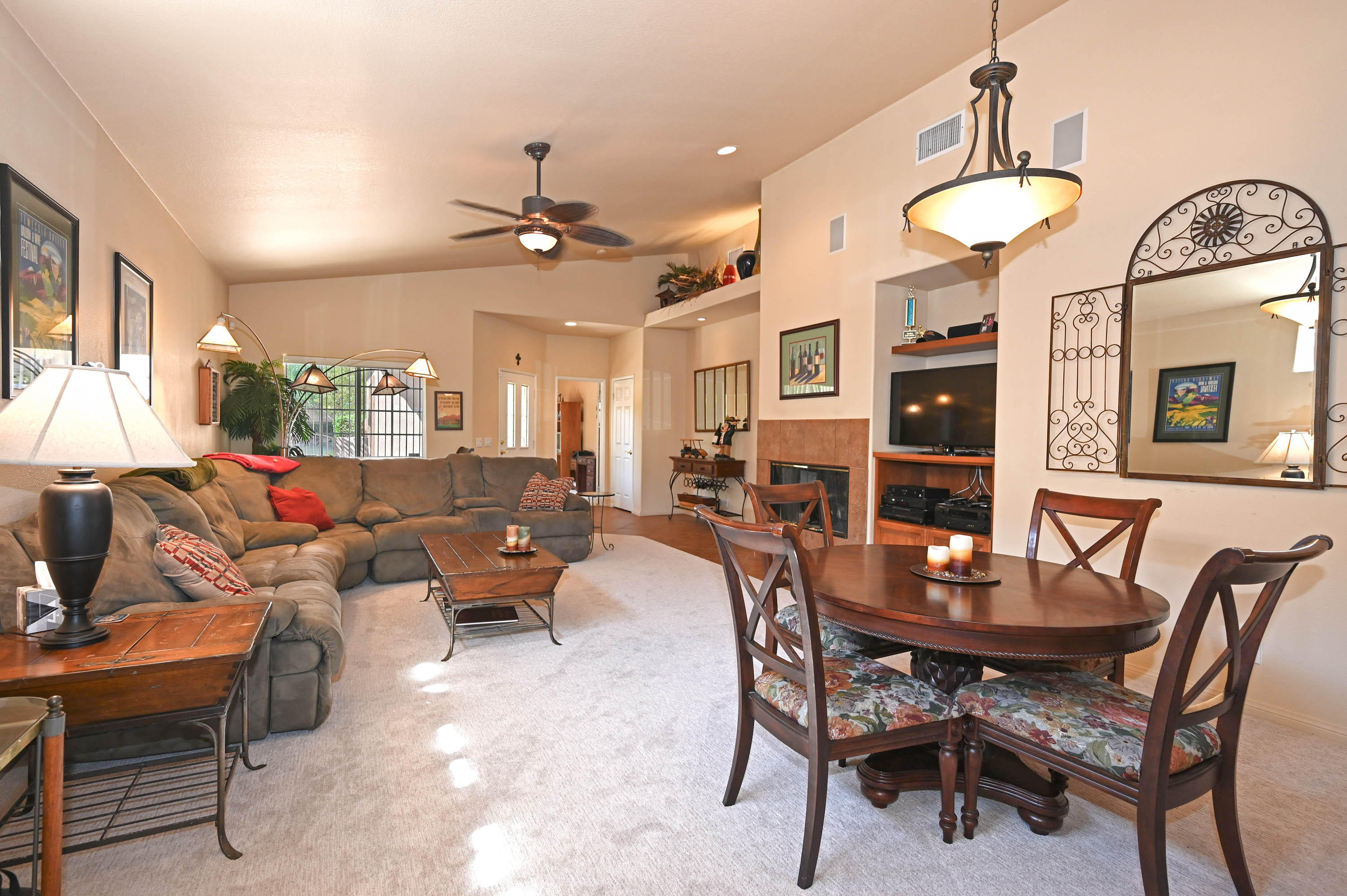 45204 Banff Springs Street Indio, CA 92201 - Photo 24 of 36 a living room with furniture a chandelier and a window