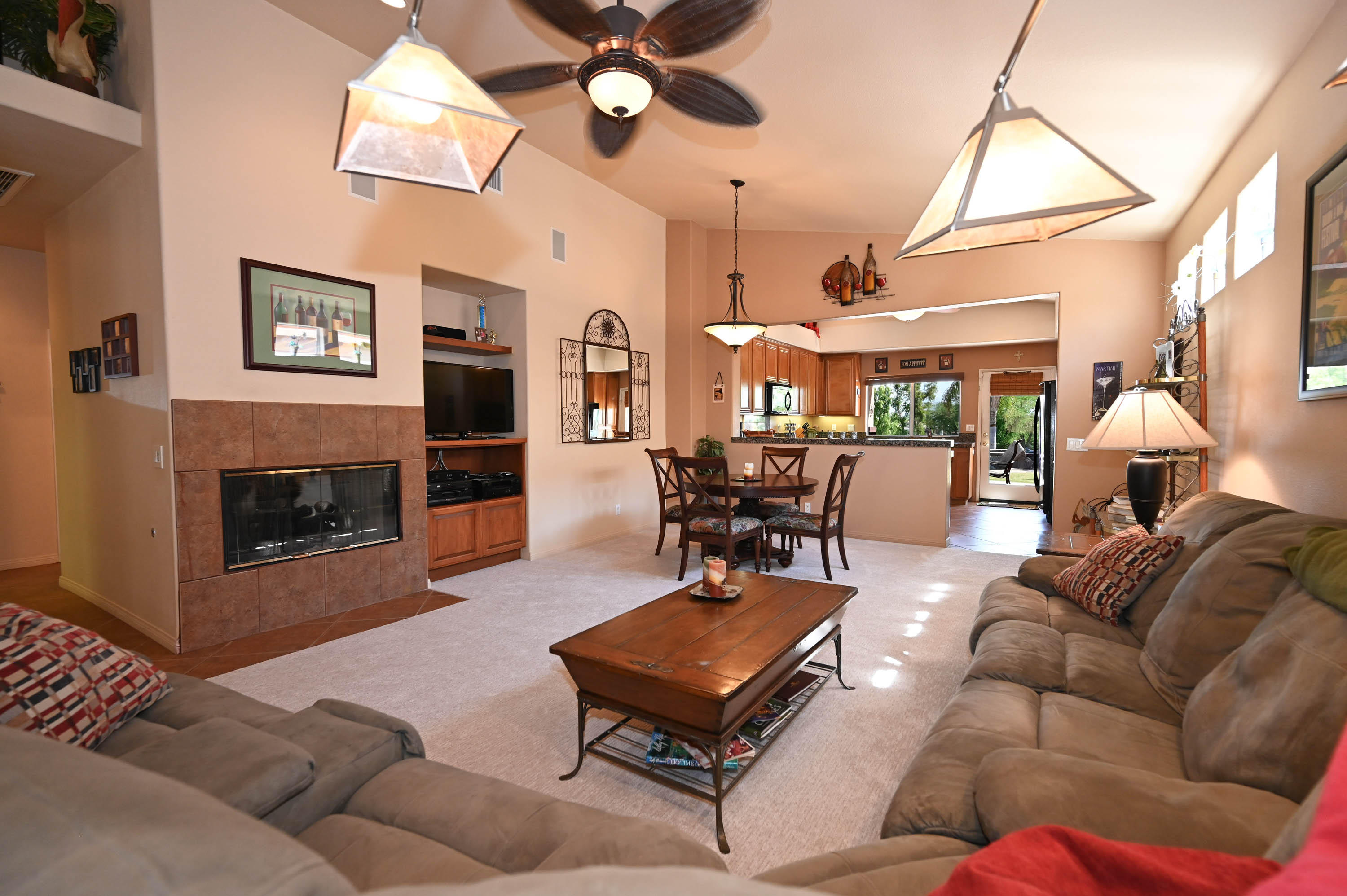 45204 Banff Springs Street Indio, CA 92201 - Photo 27 of 36 a living room with furniture a fireplace and a flat screen tv