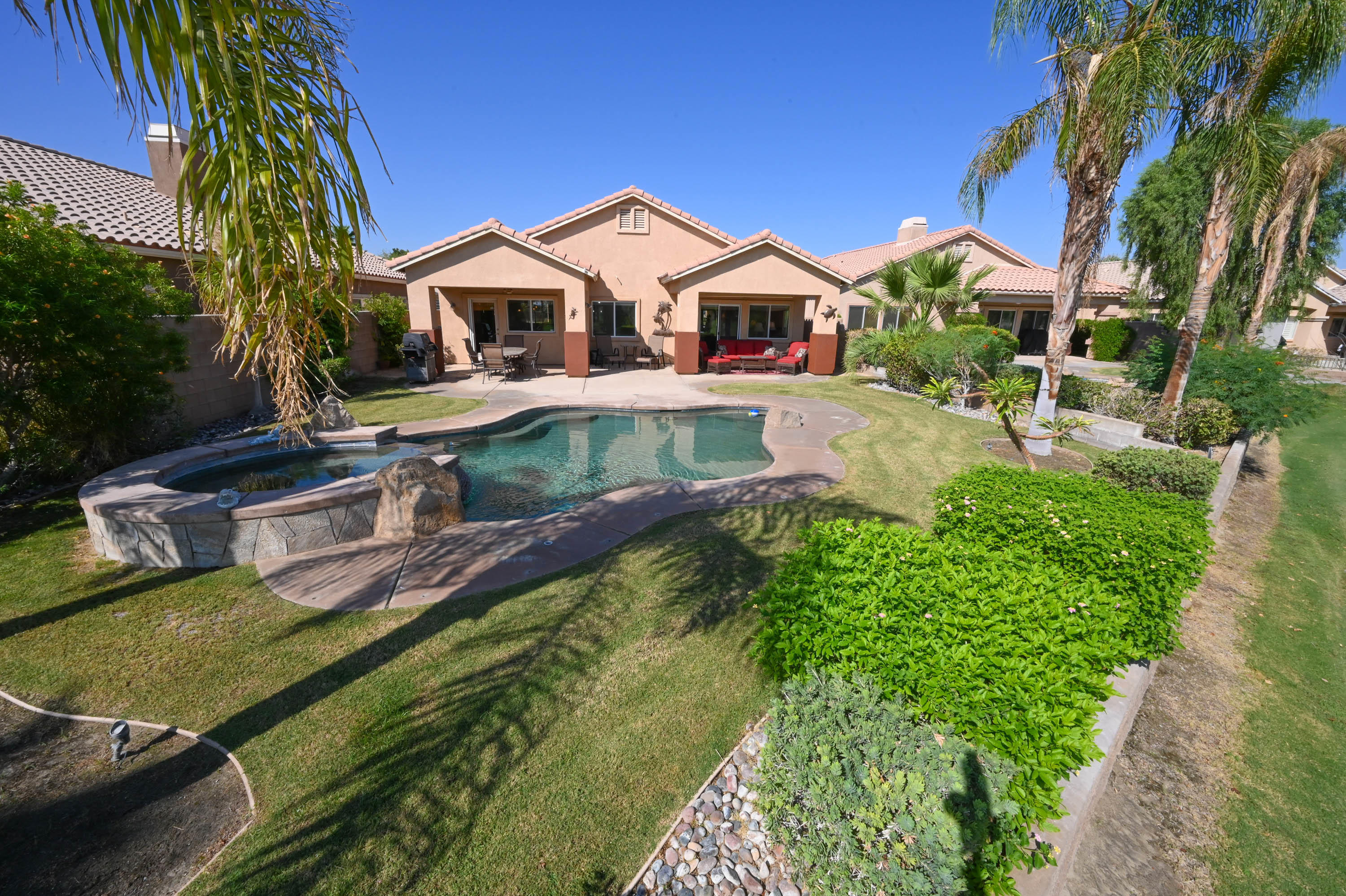 45204 Banff Springs Street Indio, CA 92201 - Photo 4 of 36 a front view of house with yard and outdoor seating