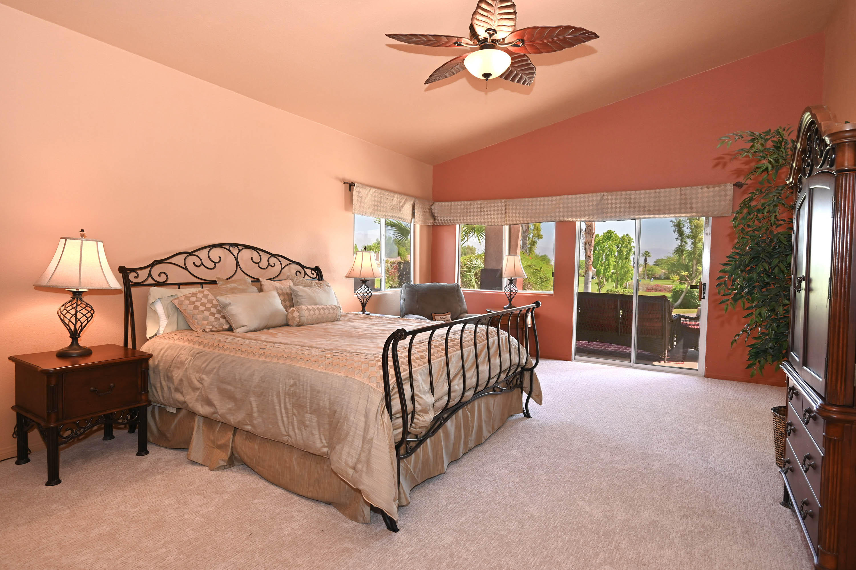 45204 Banff Springs Street Indio, CA 92201 - Photo 32 of 36 a bedroom with a bed and a chandelier