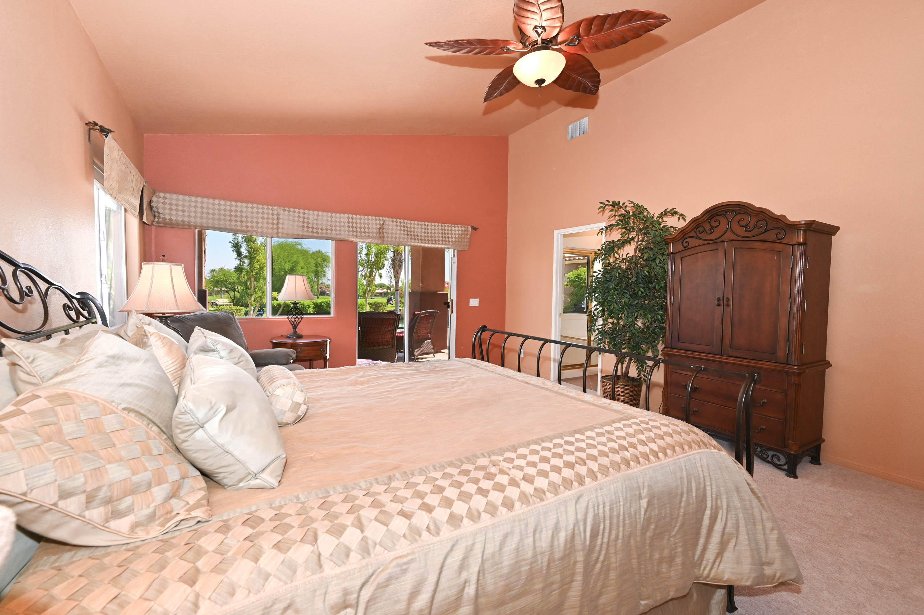 45204 Banff Springs Street Indio, CA 92201 - Photo 33 of 36 a bedroom with a bed dresser and a large window