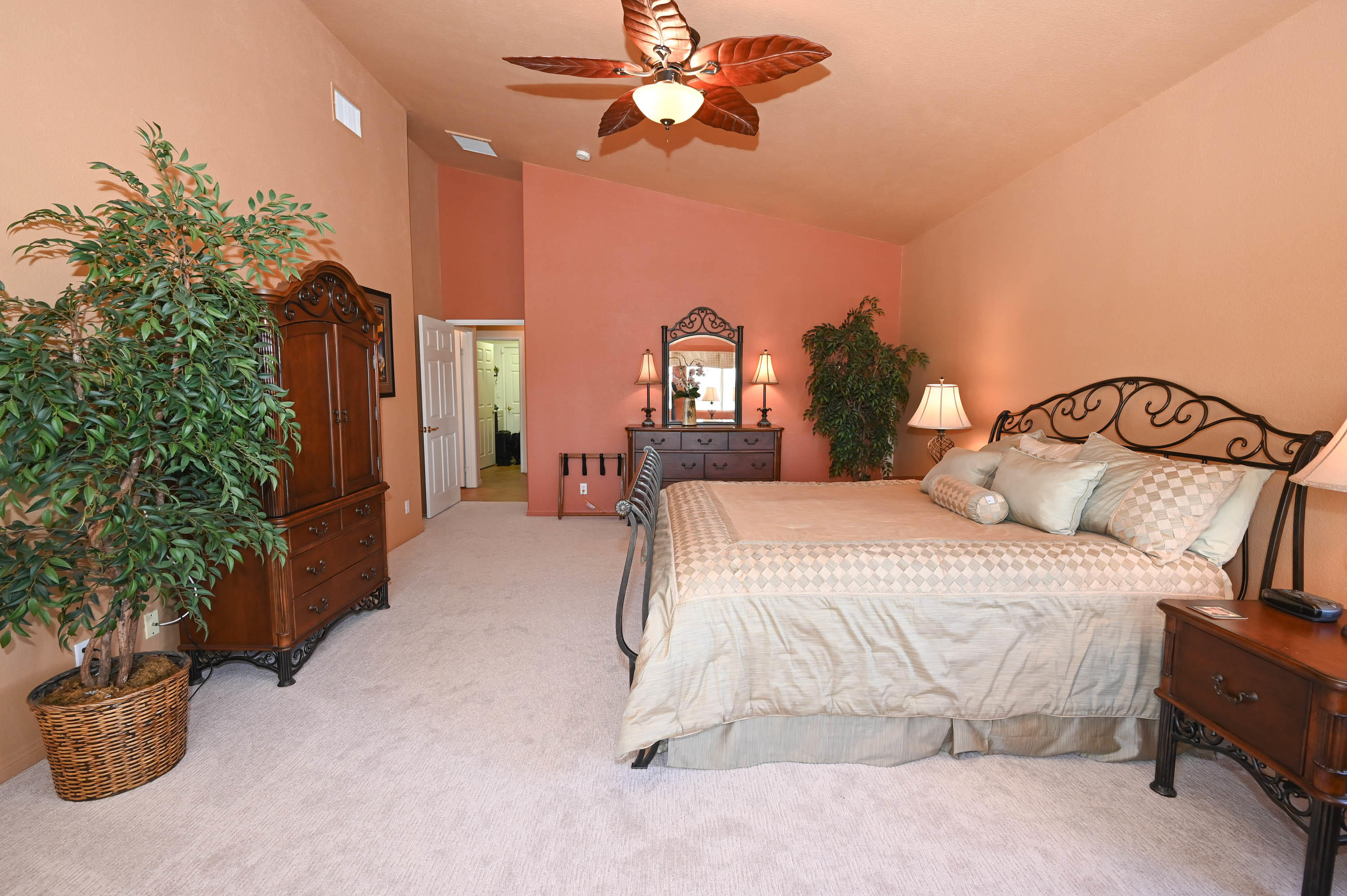 45204 Banff Springs Street Indio, CA 92201 - Photo 35 of 36 a bedroom with a bed and a chandelier