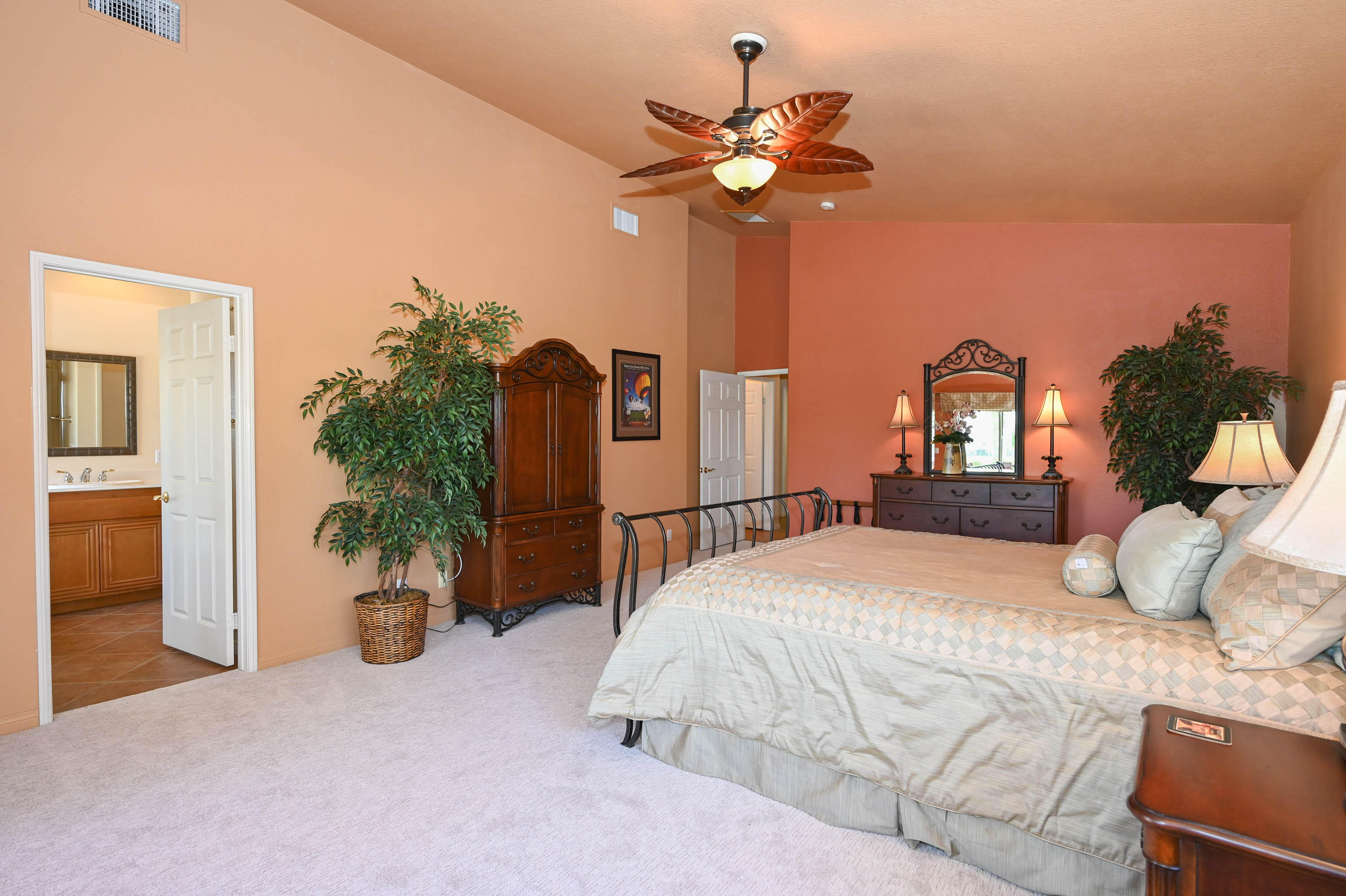 45204 Banff Springs Street Indio, CA 92201 - Photo 36 of 36 a bedroom with a large bed and potted plant