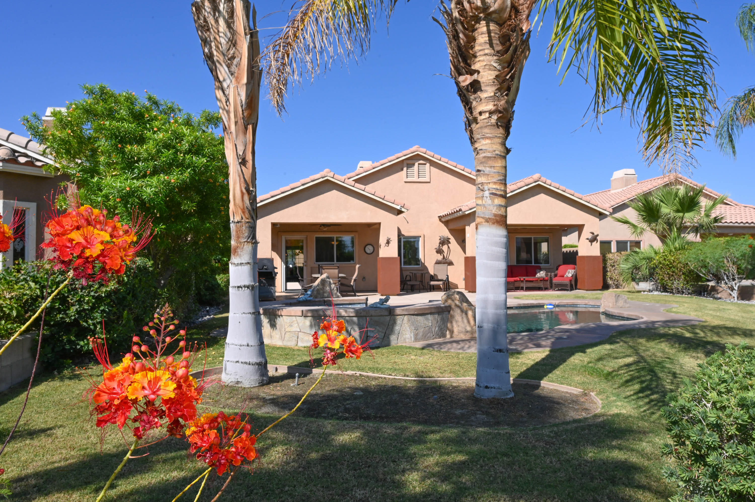 45204 Banff Springs Street Indio, CA 92201 - Photo 5 of 36 a view of a house with backyard and sitting area