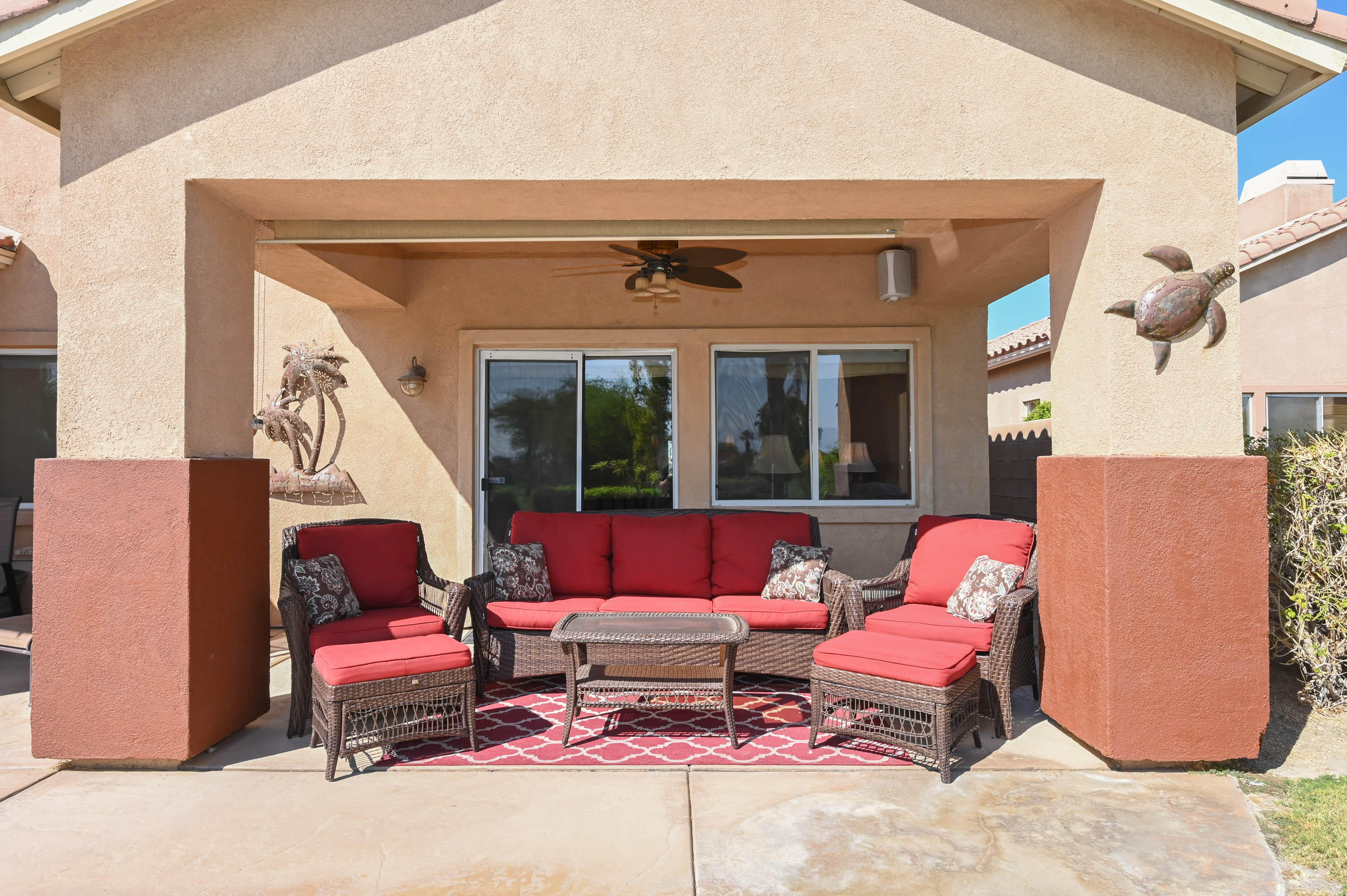 45204 Banff Springs Street Indio, CA 92201 - Photo 7 of 36 a outdoor living space with furniture and a fireplace