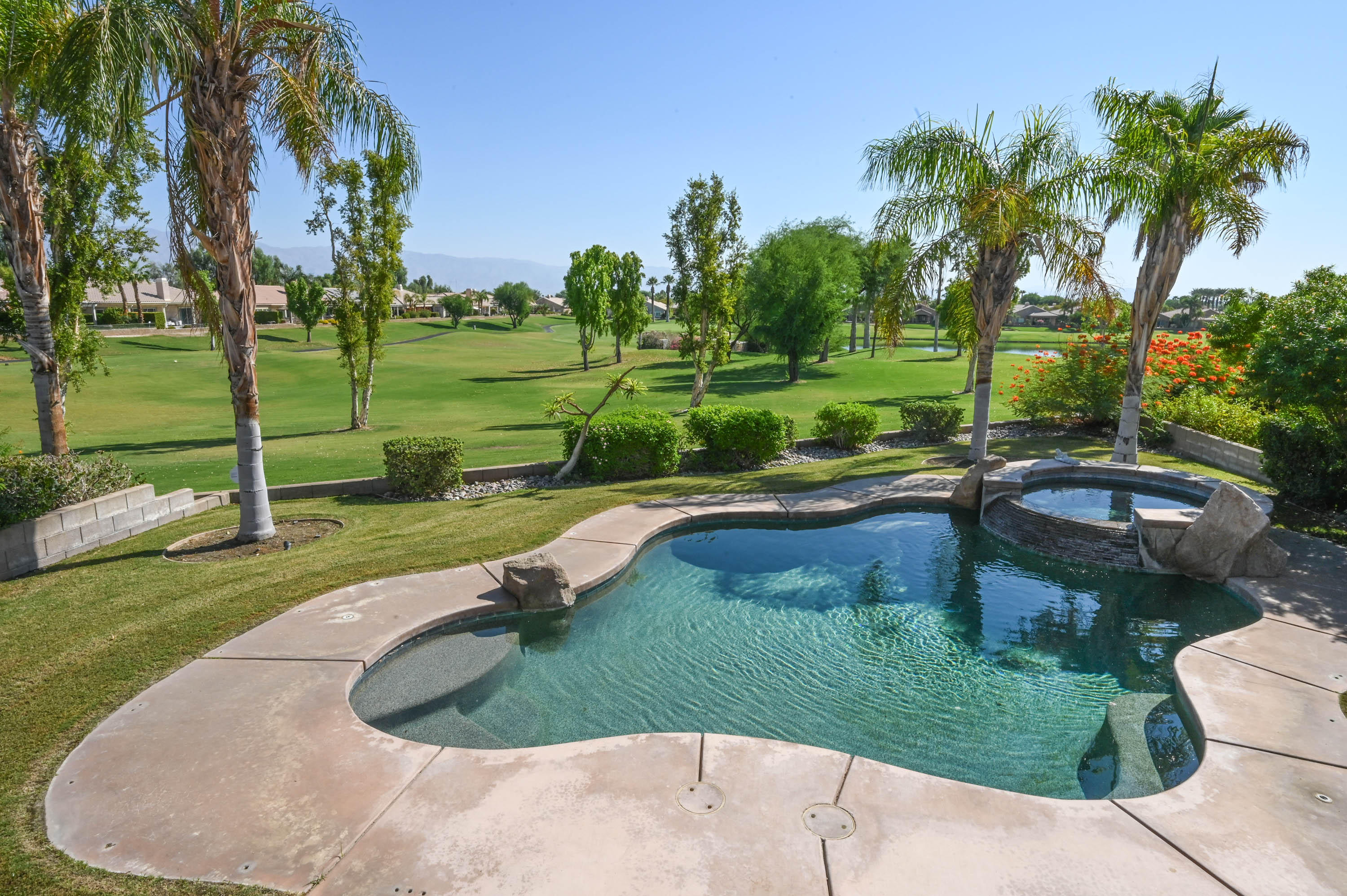 45204 Banff Springs Street Indio, CA 92201 - Photo 10 of 36 a view of a swimming pool with a patio