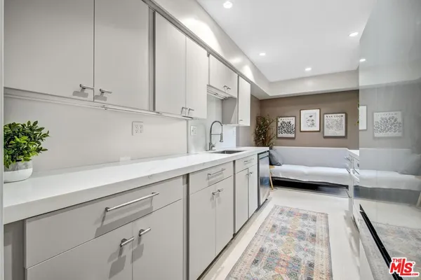 a spacious en suite bathroom with a double vanity sink and mirror