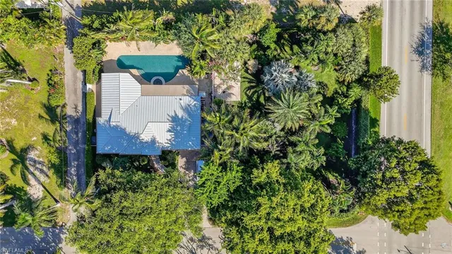 an aerial view of a house with a yard and garden