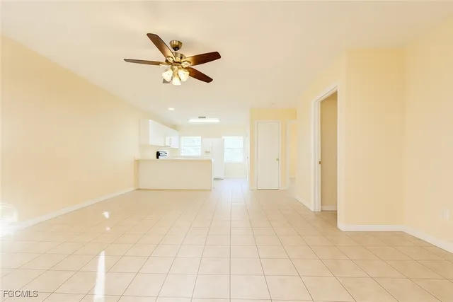 a view of a livingroom with a ceiling fan and window