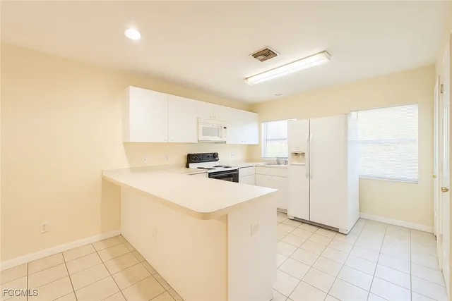 a kitchen with a sink a counter top space and cabinets