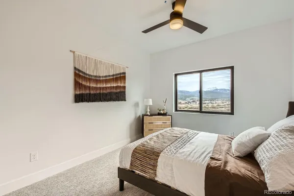 a bedroom with a bed and a painting on the wall