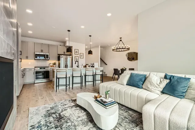 a living room with furniture and kitchen view