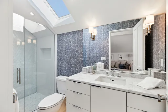 a bedroom with a large bed and a wooden floor