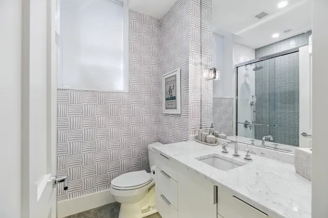 a bathroom with a sink double vanity and a mirror