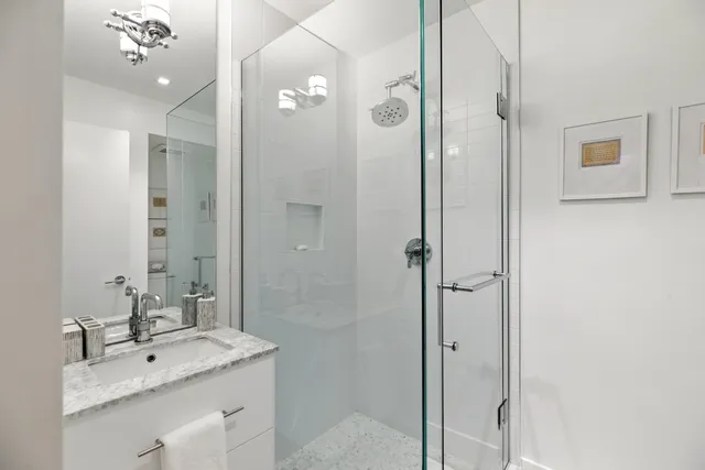a bathroom with a sink toilet and shower