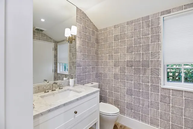 a balcony with wooden floor table and chairs