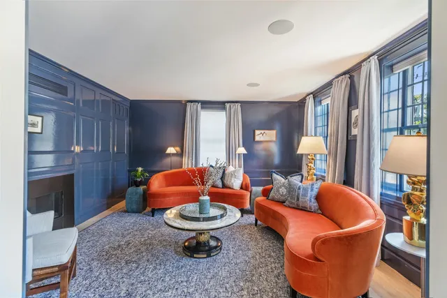 a living room with furniture a lamp and a fireplace