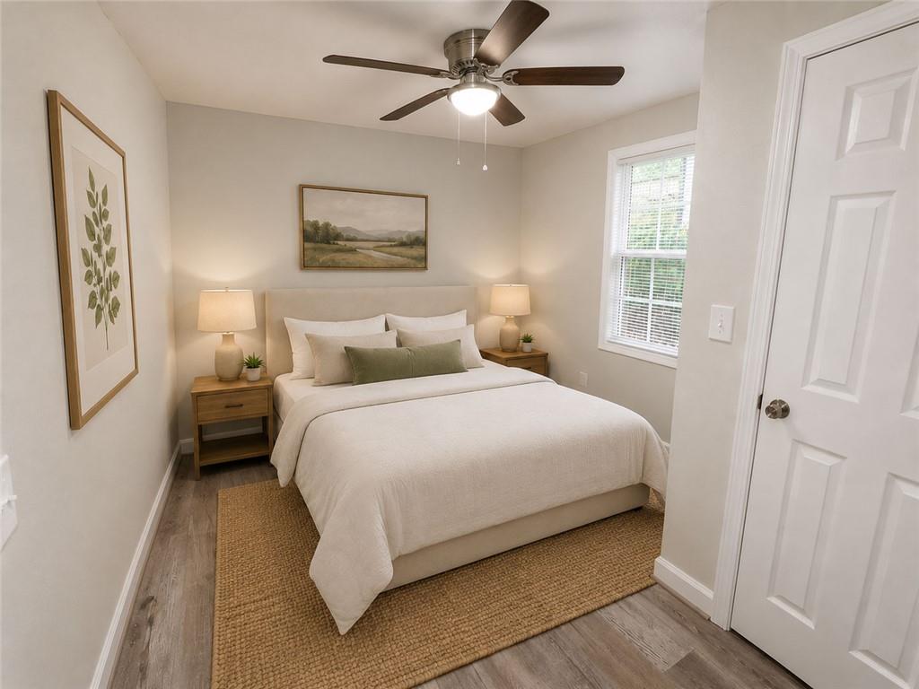1280 Elizabeth Avenue Southwest Atlanta, GA 30310 - Photo 8 of 11 a bedroom with a bed and a painting on the wall