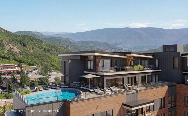 a front view of a house with swimming pool and a yard