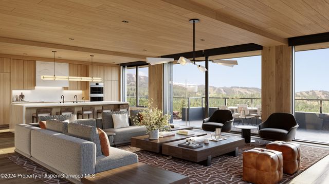 a living room with furniture and floor to ceiling windows