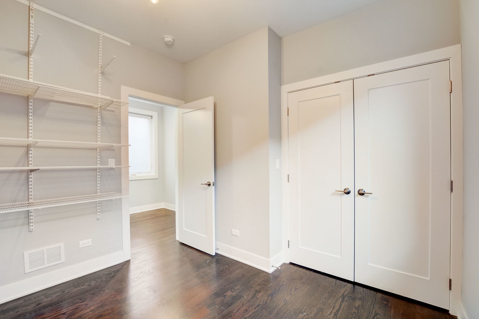 3303 South Racine Avenue Chicago, IL 60608 - Photo 28 of 60 a view of an empty room with wooden floor
