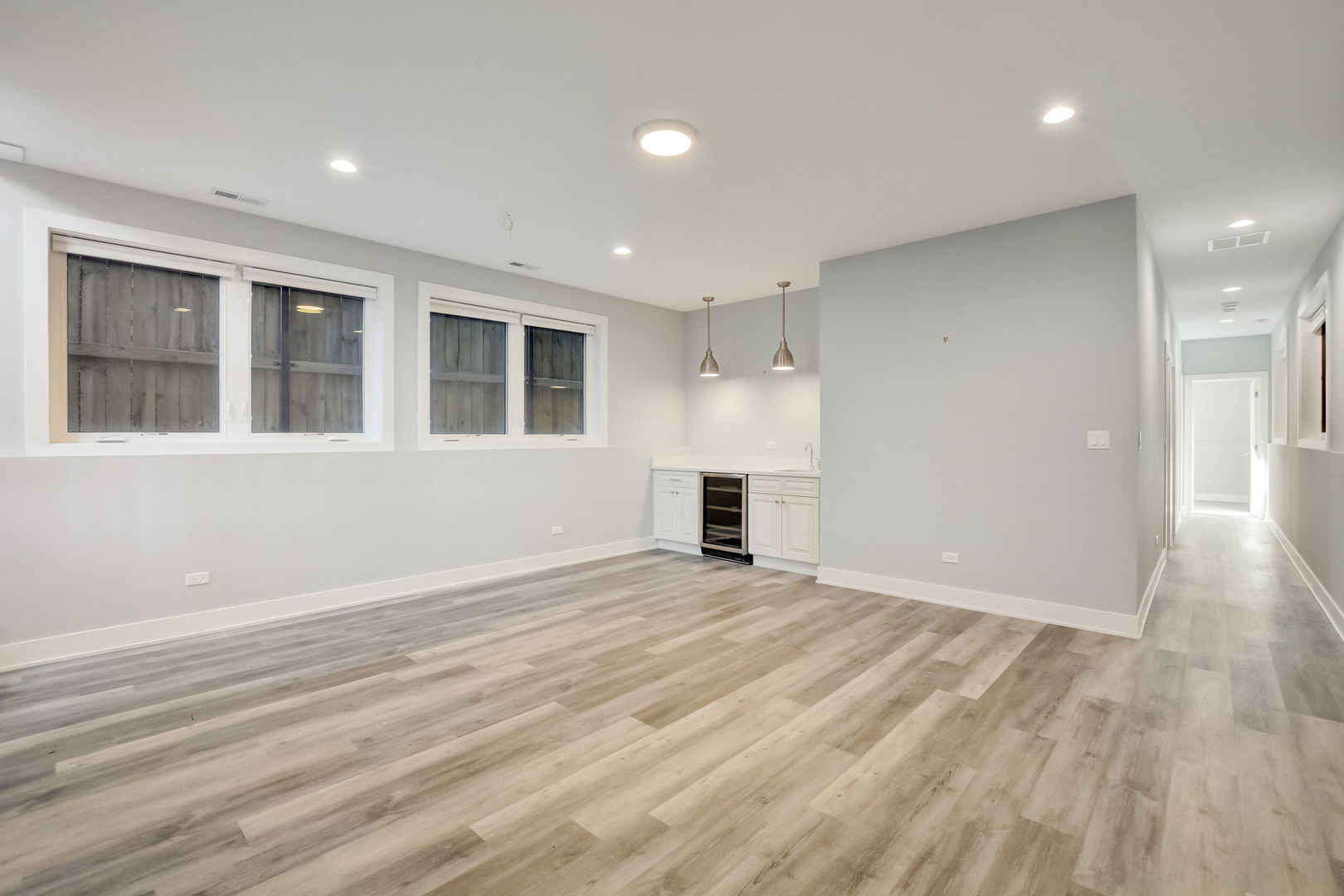 3303 South Racine Avenue Chicago, IL 60608 - Photo 38 of 60 an empty room with wooden floor and windows
