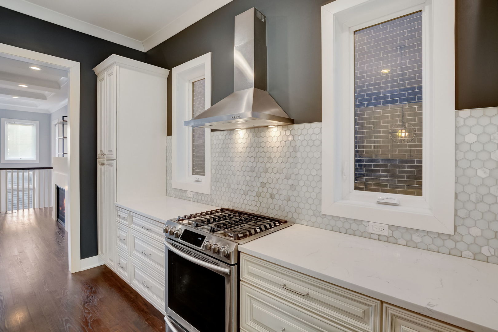 3303 South Racine Avenue Chicago, IL 60608 - Photo 9 of 60 a kitchen with a stove and white cabinets