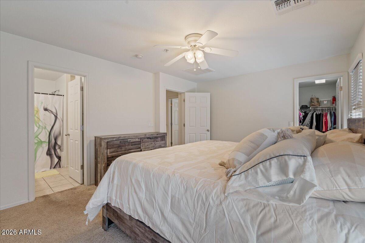 1255 South Rialto, Unit 106 Mesa, AZ 85209 - Photo 15 of 32 a bedroom with a bed and a chandelier